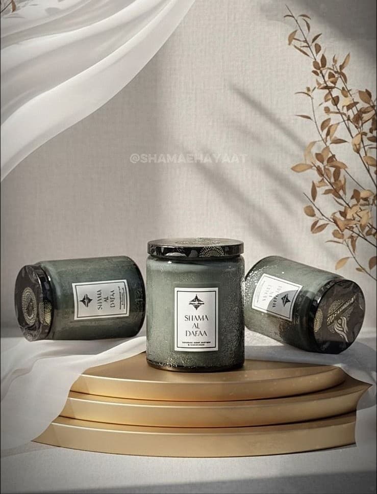 Shama-e-Hayaat candles staged beneath a flowing curtain